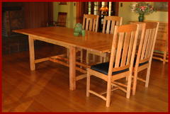 Shown with the two leaves installed and two chairs at the end of the table.